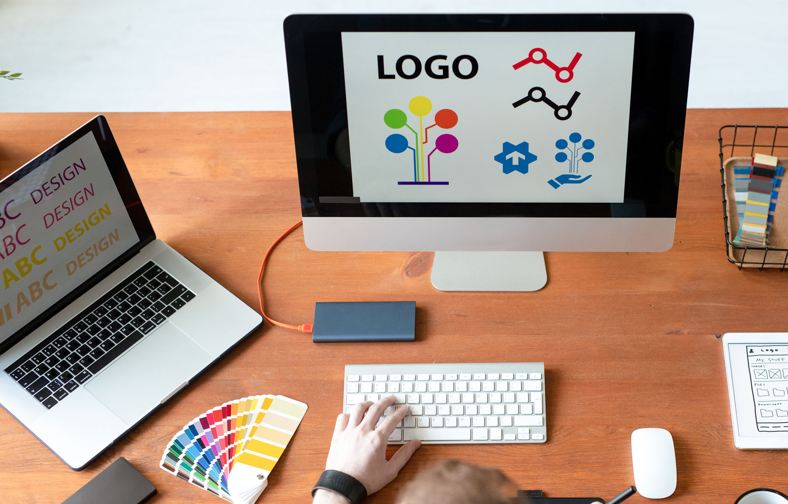 Graphic designer creating logo designs on an imac