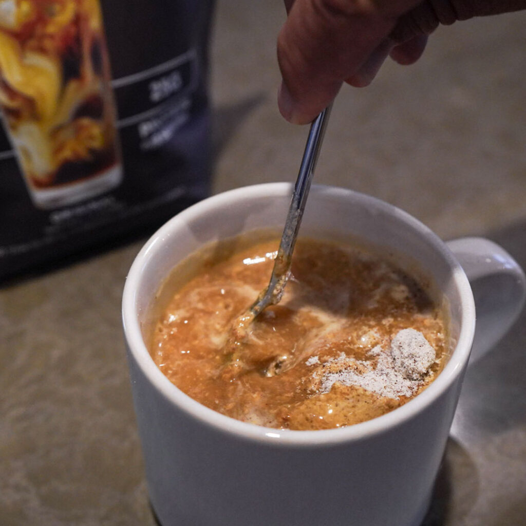 Spoon in a white coffee much stirring the Original Invigor8 High Protein Coffee